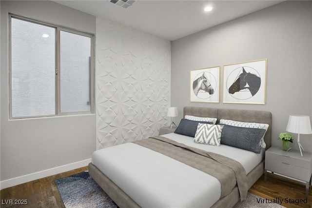 bedroom featuring wood finished floors, baseboards, and recessed lighting