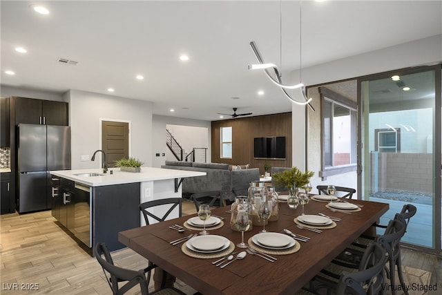 dining area featuring stairs, light wood-style floors, recessed lighting, and a ceiling fan
