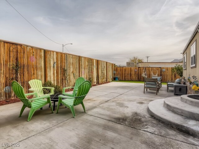 view of patio featuring a fire pit and a fenced backyard