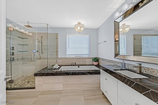 3171 Biccari Ave, Henderson, NV 89044 - full bathroom with a chandelier, a shower stall, a garden tub, vanity, and tile patterned floors