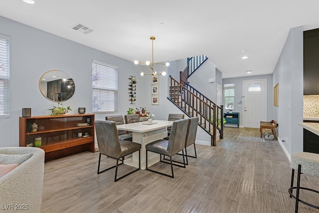 3171 Biccari Ave, Henderson, NV 89044 - dining room featuring stairs, light wood-style flooring, a chandelier, and recessed lighting