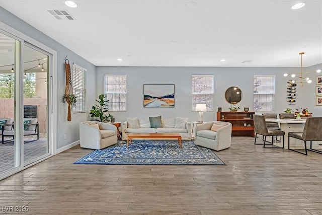 3171 Biccari Ave, Henderson, NV 89044 - living room with wood finished floors, plenty of natural light, recessed lighting, a chandelier, and baseboards