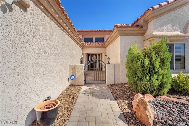 9916 Netherton Dr, Las Vegas, NV 89134 - entrance to property with a gate, stucco siding, and a tiled roof