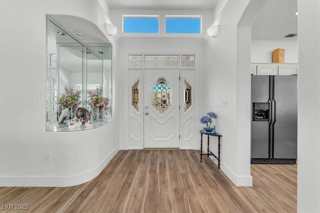 9916 Netherton Dr, Las Vegas, NV 89134 - foyer with arched walkways, baseboards, and light wood-type flooring
