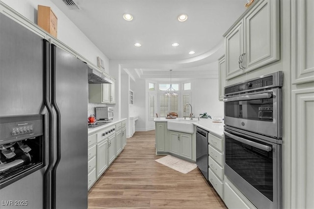 9916 Netherton Dr, Las Vegas, NV 89134 - kitchen featuring appliances with stainless steel finishes, a sink, recessed lighting, a peninsula, and light countertops