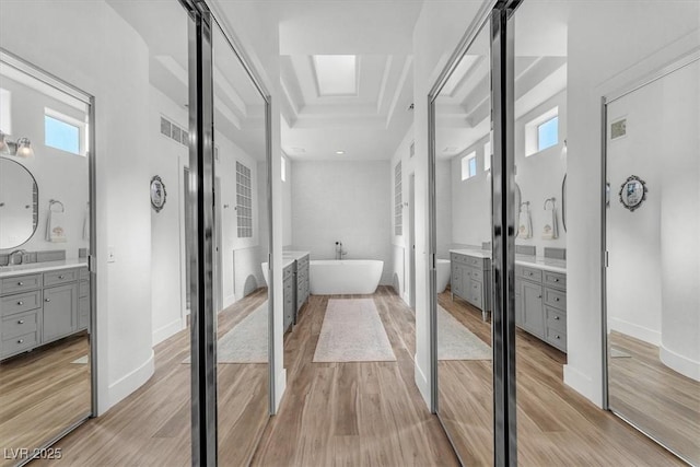 9916 Netherton Dr, Las Vegas, NV 89134 - bathroom with a soaking tub, wood finished floors, vanity, and baseboards