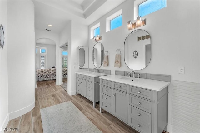9916 Netherton Dr, Las Vegas, NV 89134 - ensuite bathroom with wood finished floors, baseboards, and two vanities