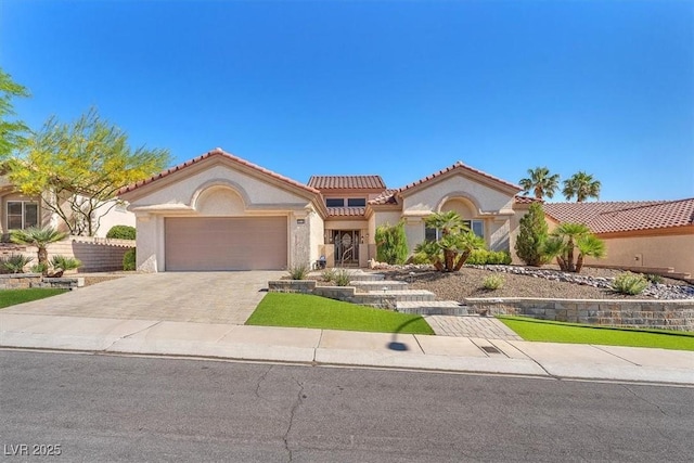 9916 Netherton Dr, Las Vegas, NV 89134 - mediterranean / spanish house featuring stucco siding, an attached garage, a tiled roof, and driveway