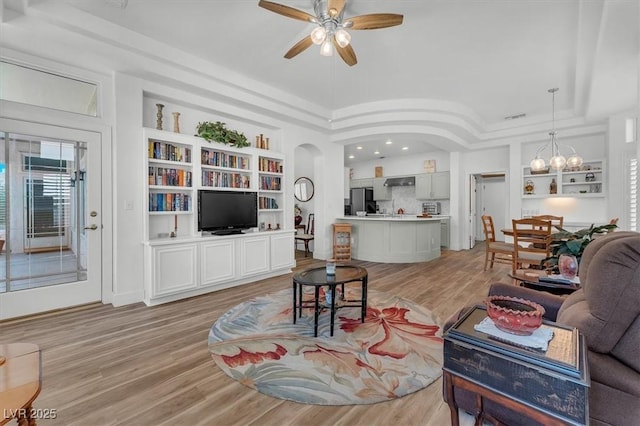 9916 Netherton Dr, Las Vegas, NV 89134 - living room featuring ceiling fan, light wood-style flooring, arched walkways, built in shelves, and recessed lighting