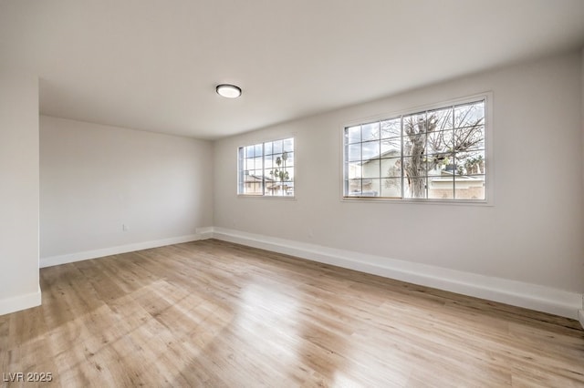 empty room featuring light wood-style floors and baseboards