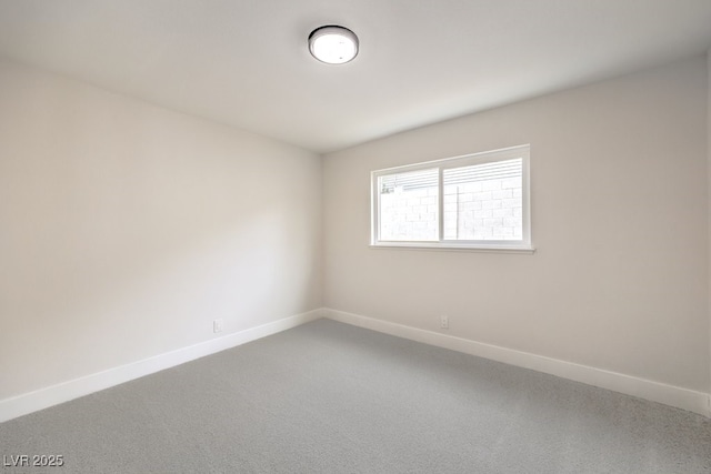 empty room with baseboards and carpet flooring