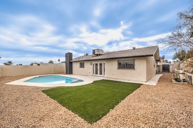 back of house with french doors, stucco siding, and a patio