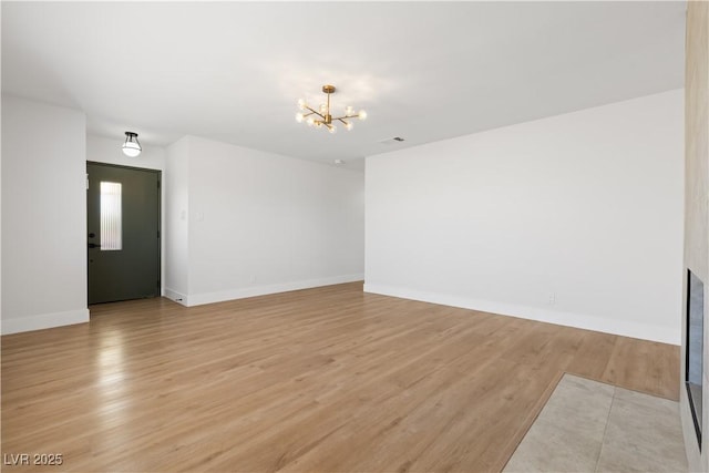 4450 San Rafael Ave, Las Vegas, NV 89120 - empty room with a chandelier, light wood-style floors, and baseboards