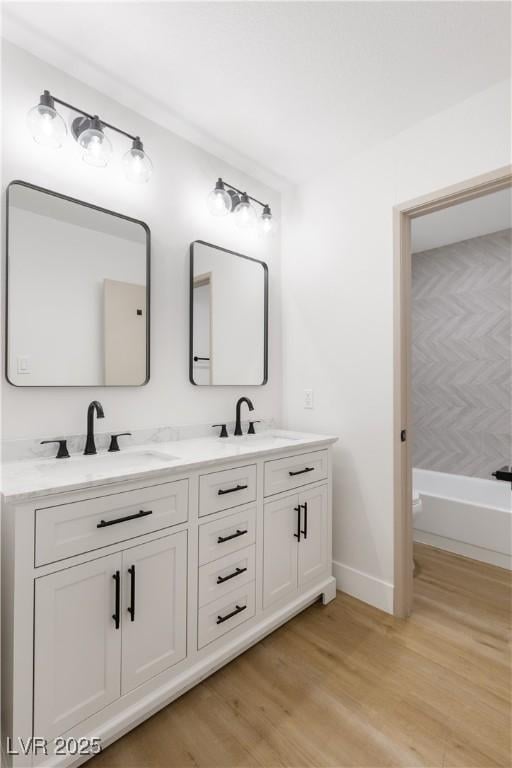 4450 San Rafael Ave, Las Vegas, NV 89120 - full bathroom featuring double vanity, wood finished floors, and baseboards