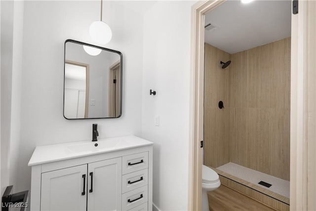 4450 San Rafael Ave, Las Vegas, NV 89120 - bathroom featuring tiled shower, vanity, toilet, and wood finished floors