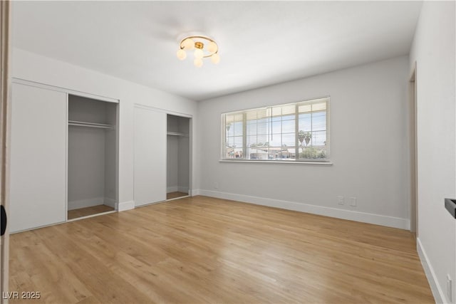 4450 San Rafael Ave, Las Vegas, NV 89120 - unfurnished bedroom with two closets, light wood-style flooring, and baseboards