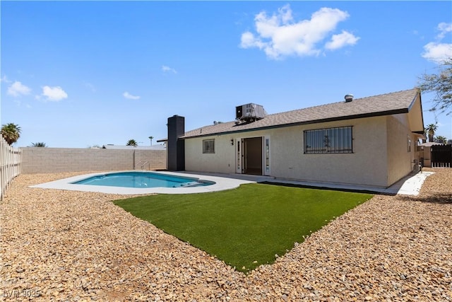 4450 San Rafael Ave, Las Vegas, NV 89120 - back of house with a fenced backyard, stucco siding, cooling unit, a chimney, and a patio area