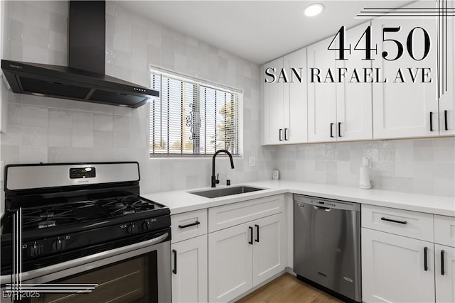 4450 San Rafael Ave, Las Vegas, NV 89120 - kitchen featuring appliances with stainless steel finishes, wall chimney exhaust hood, a sink, decorative backsplash, and recessed lighting