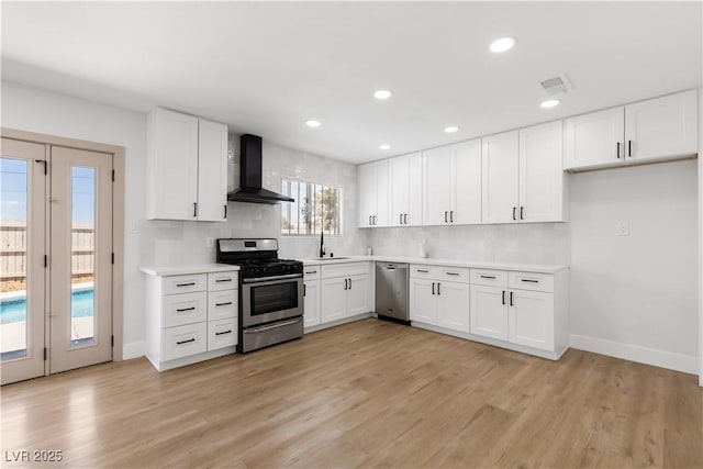 4450 San Rafael Ave, Las Vegas, NV 89120 - kitchen featuring appliances with stainless steel finishes, wall chimney range hood, decorative backsplash, a sink, and baseboards