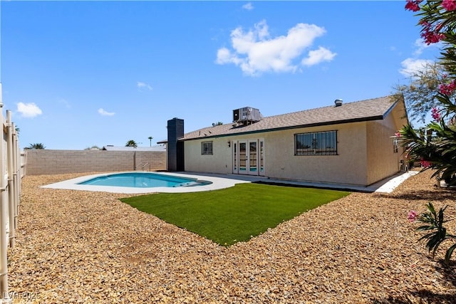 4450 San Rafael Ave, Las Vegas, NV 89120 - back of property featuring french doors, a fenced backyard, stucco siding, and central AC