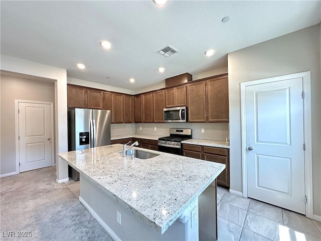 483 Fairview Hills St, Las Vegas, NV 89138 - kitchen featuring stainless steel appliances, a kitchen island with sink, light stone countertops, recessed lighting, and dark brown cabinets