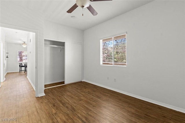 5250 S Rainbow Blvd Unit 2106, Las Vegas, NV 89118 - unfurnished bedroom featuring a closet, multiple windows, and wood finished floors