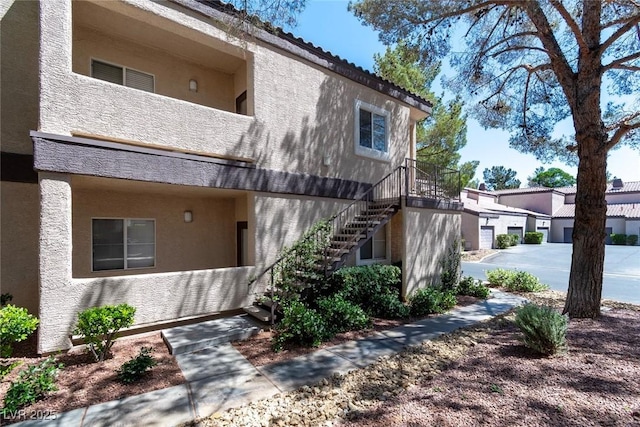 5250 S Rainbow Blvd Unit 2106, Las Vegas, NV 89118 - view of property exterior with stucco siding and stairway