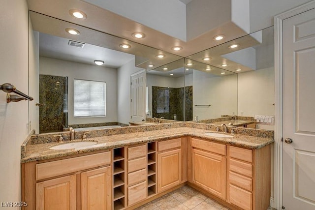 bathroom with recessed lighting, a stall shower, double vanity, and tile patterned flooring