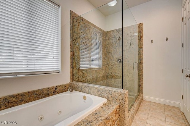 bathroom featuring a stall shower, a whirlpool tub, and tile patterned floors