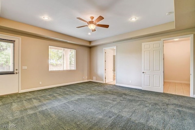 unfurnished bedroom with carpet flooring, baseboards, recessed lighting, ensuite bathroom, and a ceiling fan