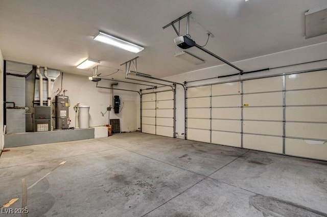 garage featuring water heater, a garage door opener, and a central vacuum unit