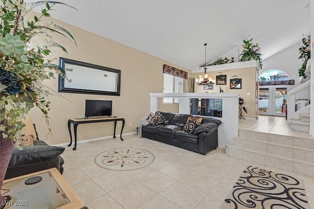 living room with light tile patterned flooring, a chandelier, french doors, baseboards, and high vaulted ceiling