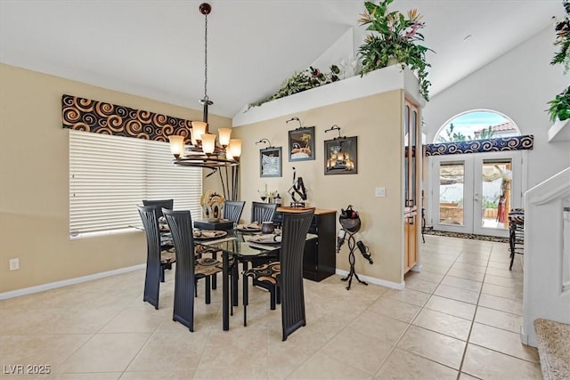 dining room with a chandelier, high vaulted ceiling, light tile patterned floors, and baseboards