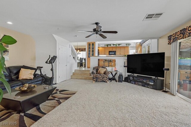 carpeted living area with stairway, ceiling fan, and recessed lighting