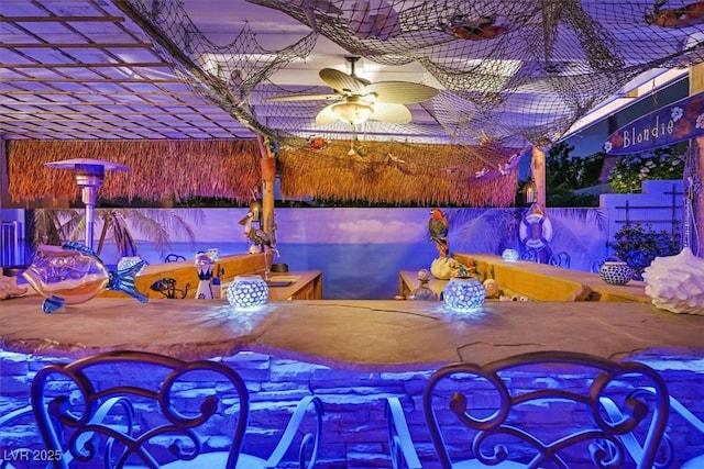 view of patio featuring outdoor dining area, ceiling fan, and fence