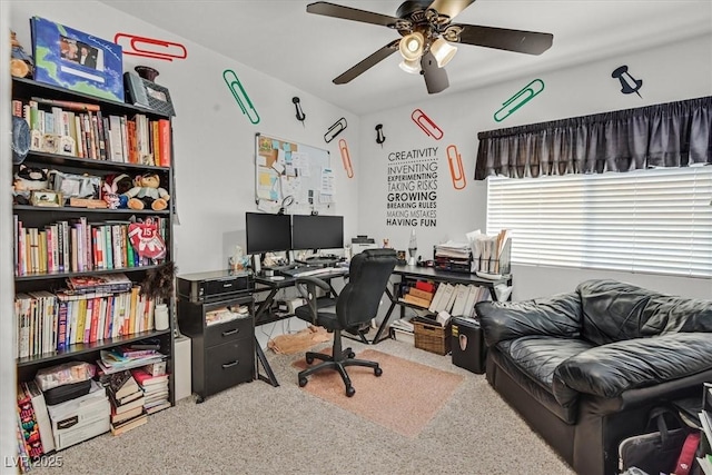 carpeted home office featuring ceiling fan