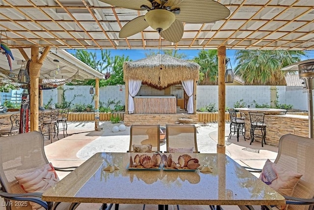 view of patio with a fenced backyard, a ceiling fan, and a pergola