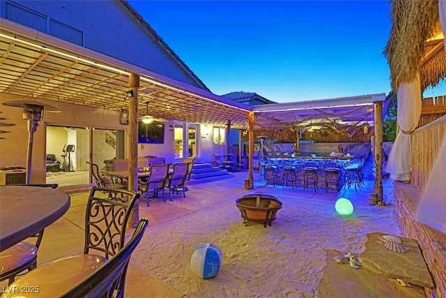 view of patio / terrace with fence, a fire pit, and outdoor dining space