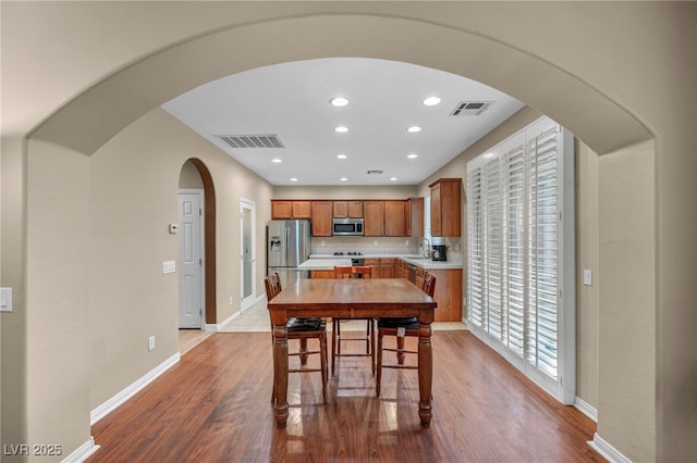 9893 Santa Ponsa Ct, Las Vegas, NV 89178 - dining room with wood finished floors, arched walkways, baseboards, and recessed lighting