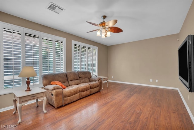 9893 Santa Ponsa Ct, Las Vegas, NV 89178 - living room featuring ceiling fan, wood finished floors, and baseboards