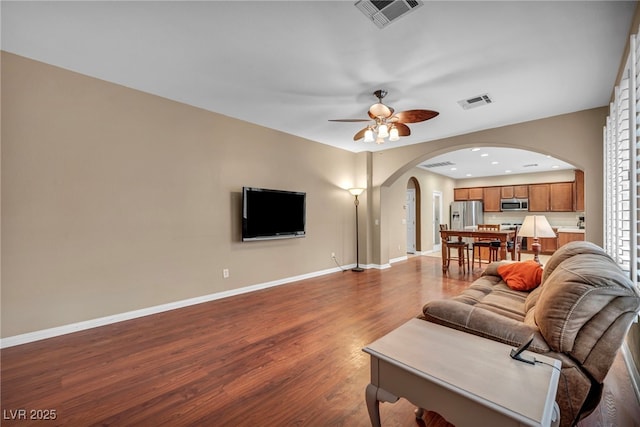 9893 Santa Ponsa Ct, Las Vegas, NV 89178 - living room with arched walkways, wood finished floors, baseboards, ceiling fan, and recessed lighting