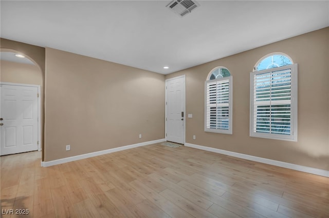 9893 Santa Ponsa Ct, Las Vegas, NV 89178 - empty room featuring baseboards, arched walkways, light wood-style flooring, and recessed lighting