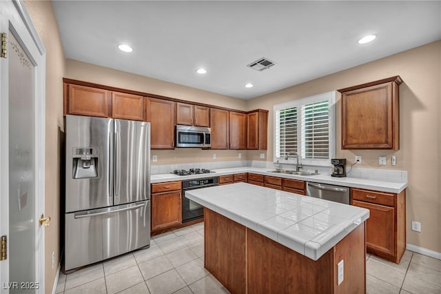 9893 Santa Ponsa Ct, Las Vegas, NV 89178 - kitchen featuring black appliances, a sink, brown cabinets, and recessed lighting