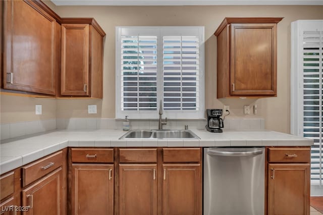 9893 Santa Ponsa Ct, Las Vegas, NV 89178 - kitchen featuring stainless steel dishwasher, a sink, brown cabinetry, and light countertops