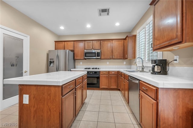 9893 Santa Ponsa Ct, Las Vegas, NV 89178 - kitchen featuring a sink, appliances with stainless steel finishes, light tile patterned flooring, brown cabinets, and recessed lighting