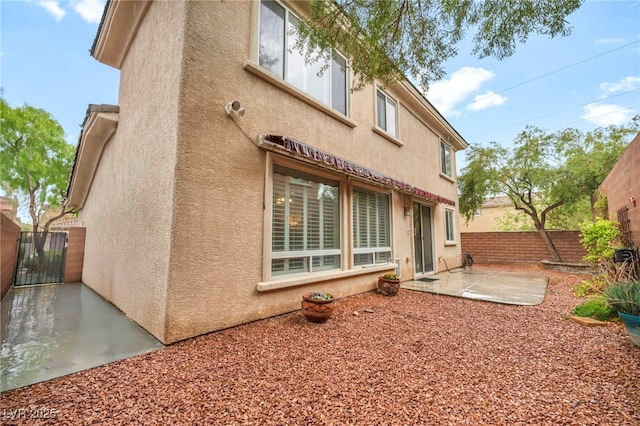 9893 Santa Ponsa Ct, Las Vegas, NV 89178 - back of property with a patio, stucco siding, and fence