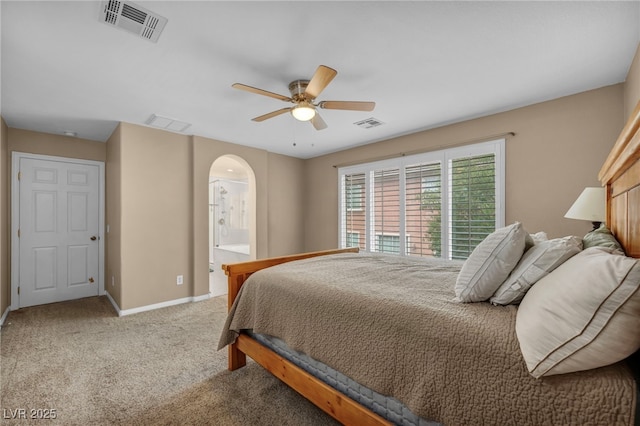 9893 Santa Ponsa Ct, Las Vegas, NV 89178 - bedroom featuring arched walkways, baseboards, carpet floors, a ceiling fan, and ensuite bath
