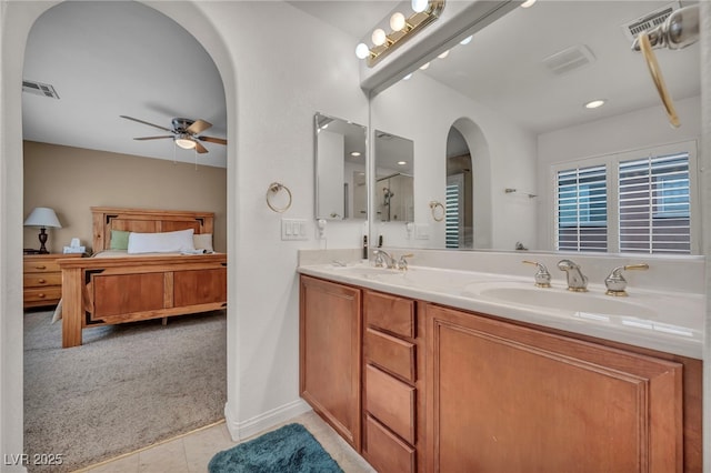 9893 Santa Ponsa Ct, Las Vegas, NV 89178 - full bath with ceiling fan, connected bathroom, double vanity, recessed lighting, and tile patterned flooring