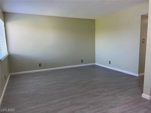 212 Orland St Unit 22, Las Vegas, NV 89107 - empty room featuring dark wood-style flooring, baseboards, and a textured ceiling