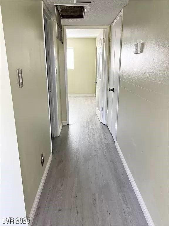 212 Orland St Unit 22, Las Vegas, NV 89107 - hall featuring wood finished floors, baseboards, and attic access